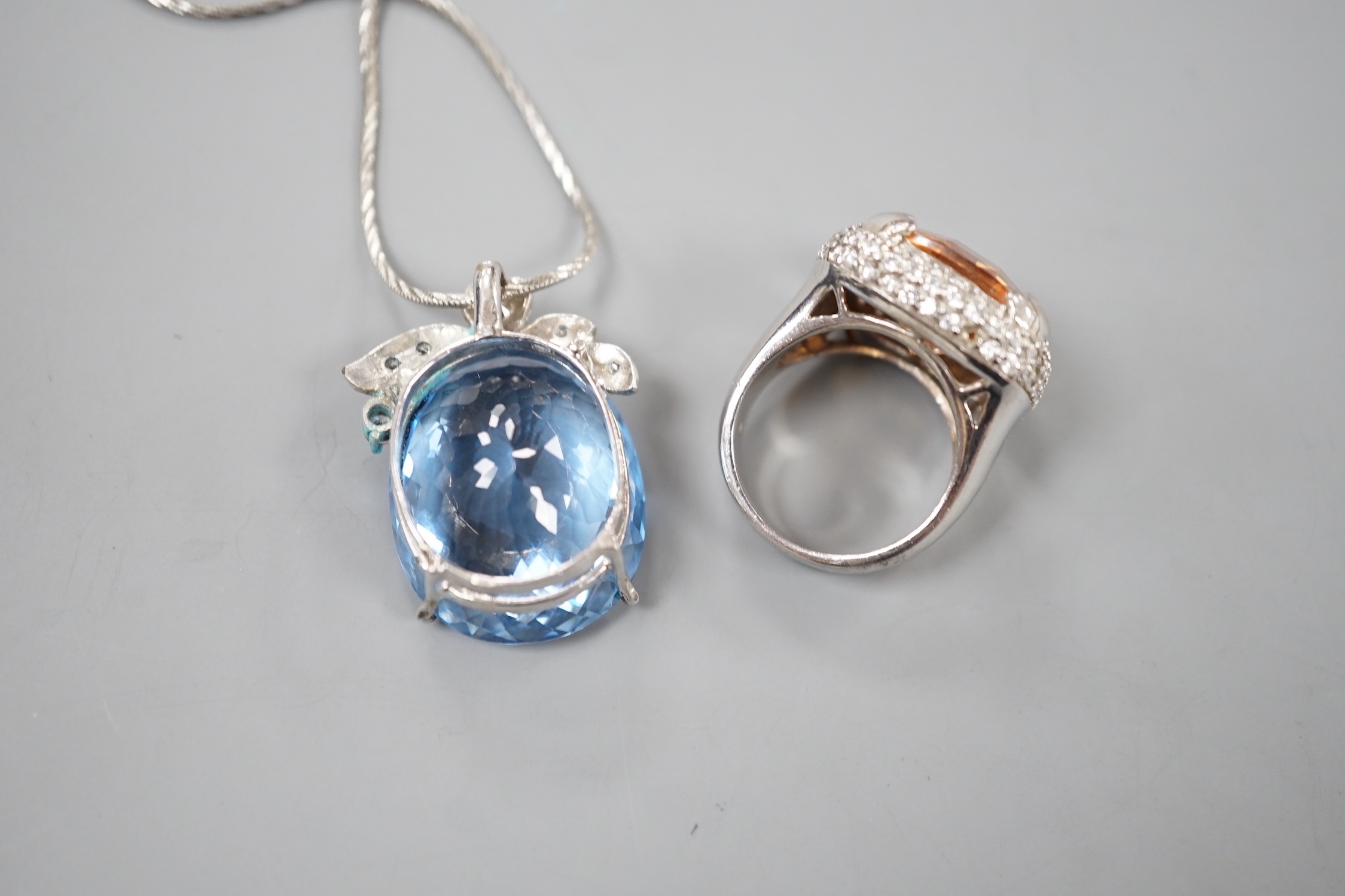 A modern 925 and paste set dress ring and a blue and white paste cluster set pendant on chain.